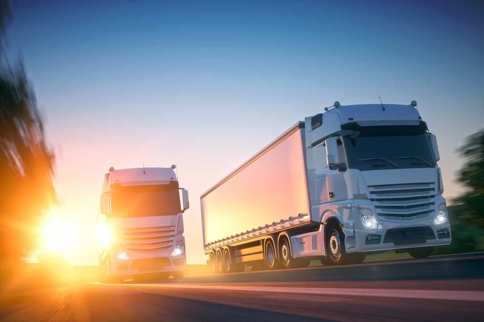Freight trucks on the highway at sunset